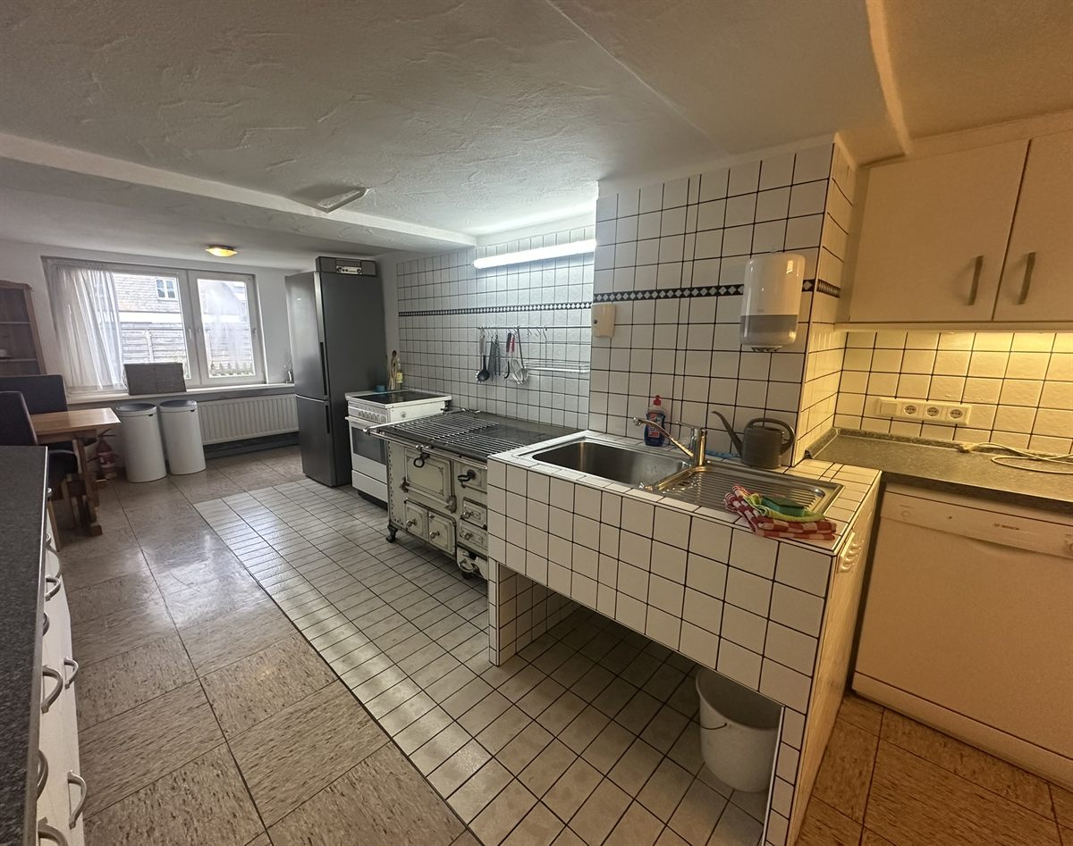 Large guest kitchen with historic enamel stove at Haus Astenalm
